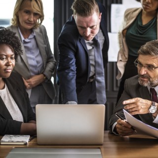 group of people looking at computer